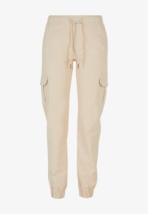 Beige cargo pants made of cotton, featuring an elastic waistband with drawstring, tapered cuffs, and side pockets. Smooth texture.