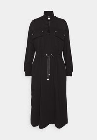 Black dress featuring a high collar, zip front, two chest pockets, elastic waistband, and a drawstring with metallic accents. Soft fabric.