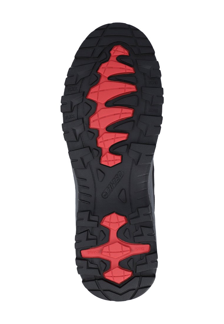 Suela de zapato de goma negra con patrón de tracción rojo. Presenta surcos profundos y zonas de agarre pronunciadas para una mayor estabilidad y durabilidad.