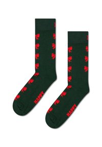 Zelené ponožky s vzorem červených mašlí, s žebrovaným lemem a vyšitým slovem "ŠŤASTNÝ" na boku.