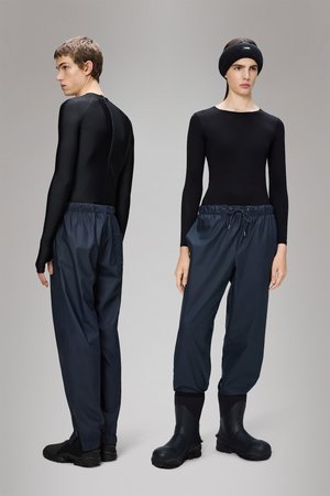Black form-fitting long-sleeve shirt, blue elastic-waist pants, and black waterproof boots, featuring a textured design and flexible fit.
