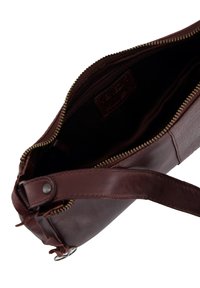 Brown leather handbag with gold zipper, textured exterior, and fabric lining. Features a strap and inner zip pocket for organization.