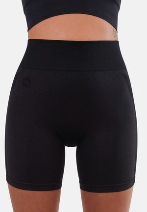 Black stretchy shorts with a high waistband, featuring smooth fabric, a fitted design, and a subtle logo detail on the side.