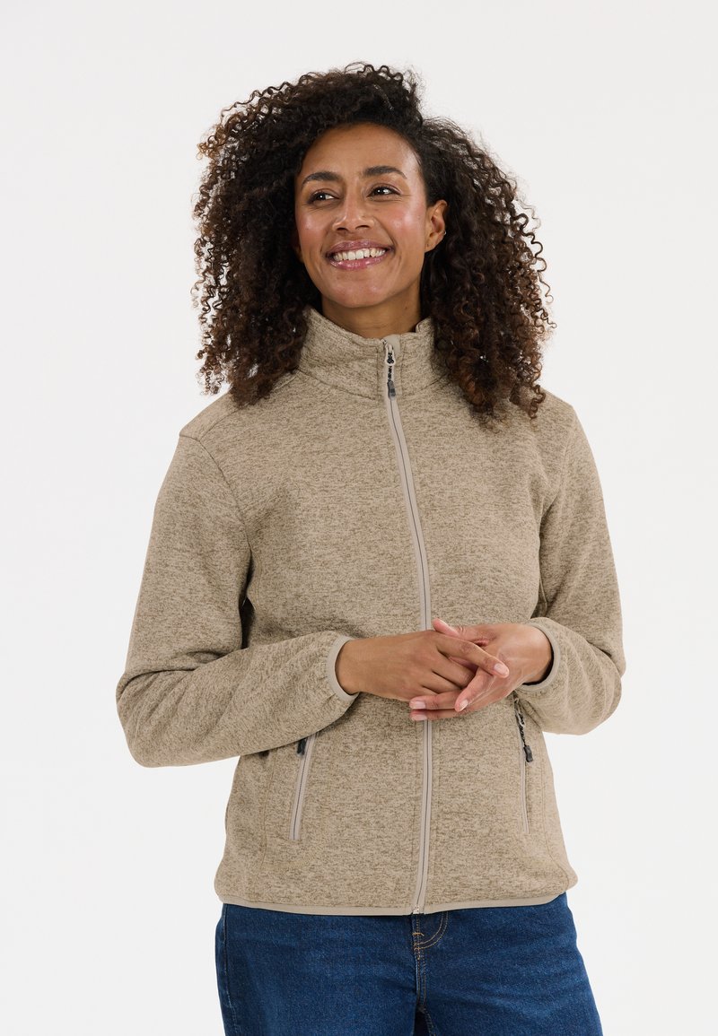 Beige zip-up fleecejacka med hög krage, sidofickor och ett texturerat mönster. Designen har ett mjukt och bekvämt tyg.