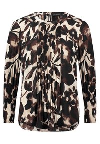 Blusa a maniche lunghe in stampa floreale crema, marrone e nera. Caratterizzata da pieghe e un colletto rotondo, realizzata in tessuto morbido.