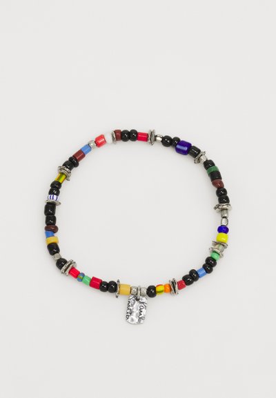 Colorful beaded necklace featuring various shaped beads in red, blue, green, black, yellow, and silver accents, with a textured metal charm.
