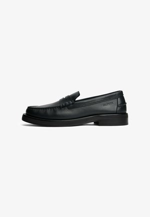 Mocassins en cuir noir avec un bout arrondi, des coutures décoratives, un petit talon carré et une bande horizontale en accent à l'avant.