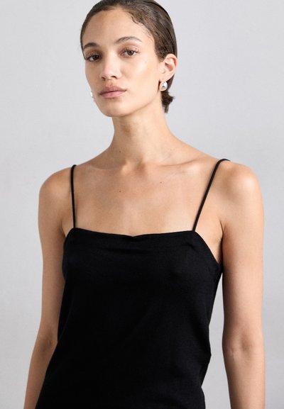 Black, sleeveless camisole with thin straps, made from a smooth fabric; features a softly rounded neckline and a fitted design.