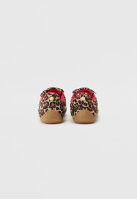 Leopard print shoes with a soft fabric upper, red interior lining, tan rubber sole, and metallic gold accents at the heel.