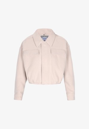 Lühendatud beež jakk pehmest kangast, millel on klassikaline kaelus, eesmine nööpide rida, kaks rinna taskut ja elastne alumine äär, et saavutada struktureeritud sobivus.