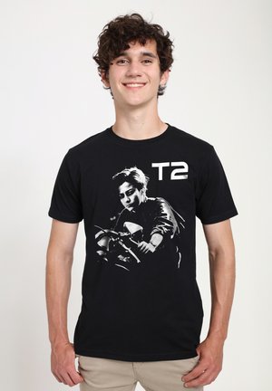 Black cotton t-shirt featuring a white graphic print of a person on a motorcycle and text "T2." Short sleeves and crew neckline.