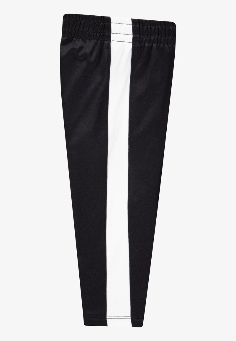 Leggings sportivi neri con una larga striscia verticale bianca sul lato. Realizzati in un tessuto liscio ed elastico, presentano una vita elasticizzata.