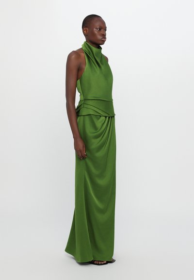 Green satin halter dress with a high neckline, draped detailing at the waist, and a long, flowing skirt. Smooth texture and fitted design.