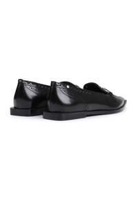 Black patent leather shoes with a rounded toe and low, rectangular heel. Features intricate brogue detailing along the sides.