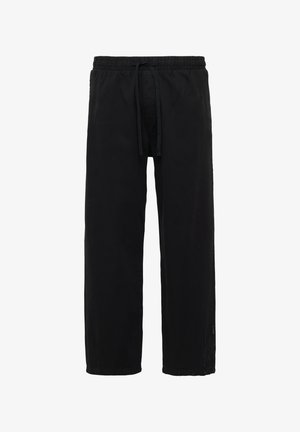 Schwarze, lässige Pants aus weichem Stoff, mit einem elastischen Taillenbund und Kordelzug, großzügigem Beinschnitt und einem schlichten Design.