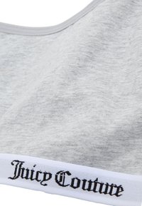 Bralette grigio in cotone con una texture liscia, caratterizzato da un elastico bianco decorato con il testo "Juicy Couture" in nero, in un font contrastante.