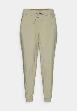 Pantalons tapered vert olive clair avec taille à cordon, poches latérales zippées et poignets élastiques.