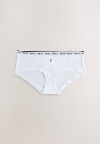 Culottes blanches en coton pour femmes avec ceinture noire estampillée "NEXT" et petite fleur brodée au centre avant.