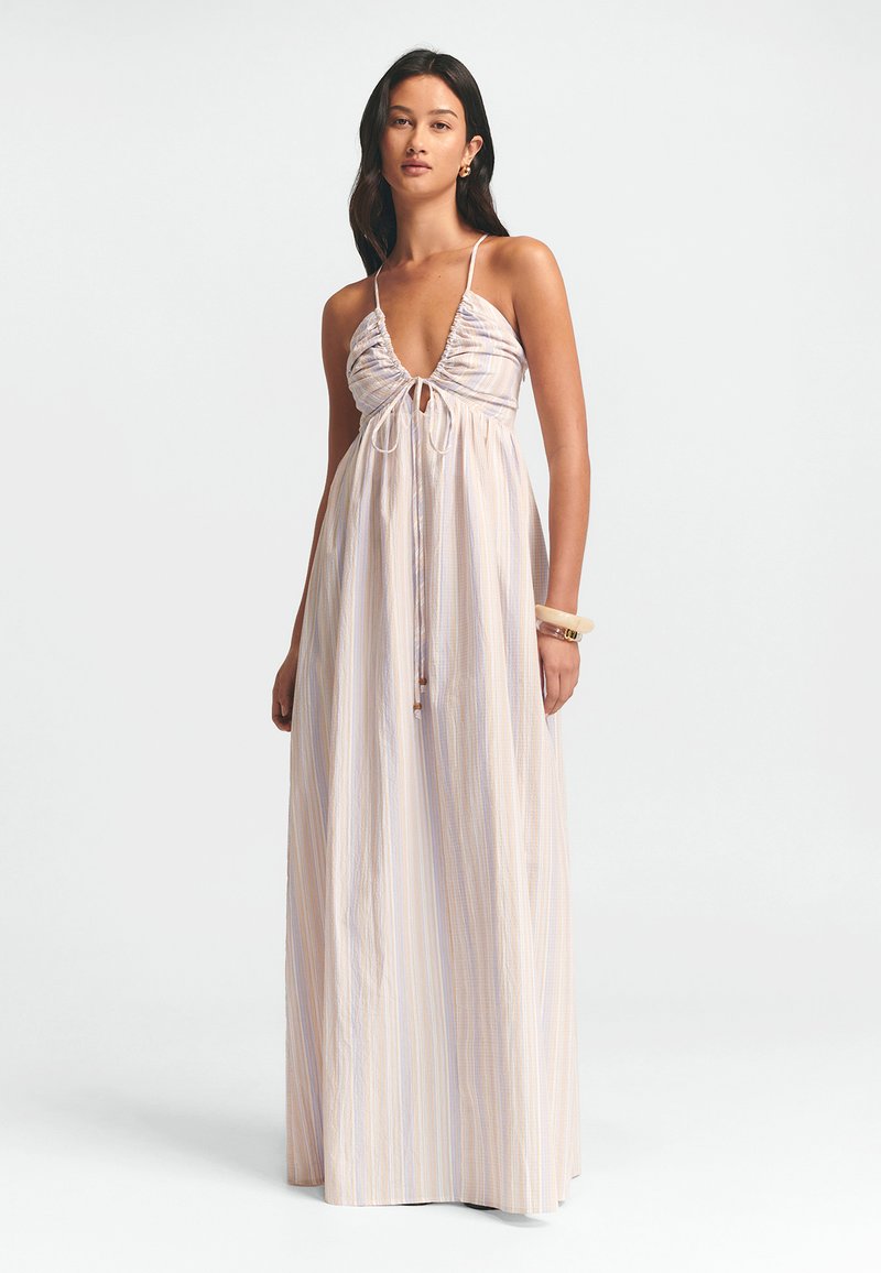 Maxi dress in lightweight, striped fabric featuring a deep V-neckline, gathered bodice, tie closure, and a relaxed fit. Colors include pastel hues.