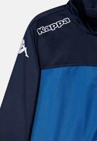 Fleece jakna z zasnovo polovičnega zadrge, blokov barv v mornarsko modri in svetlo modri barvi, beli Kappa logo na rami in gladka tekstura.