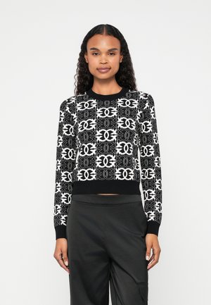 Black and white patterned sweater with long sleeves, a crew neck, and ribbed cuffs. Features a bold geometric design throughout.
