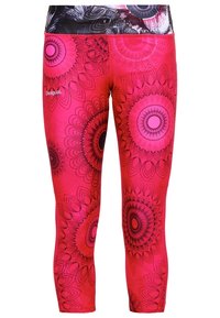 Rosa leggings med ett djärvt svart och rosa mandalamönster. Tillverkade av elastiskt tyg med en åtsittande design och en bred midjeresår.