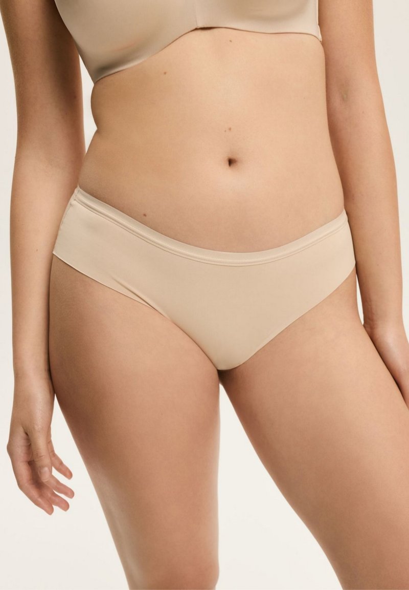 Beżowe, gładkie majtki bikini bezszwowe z elastycznym pasem, o średnim kroju, zaprojektowane dla komfortu i codziennego noszenia.