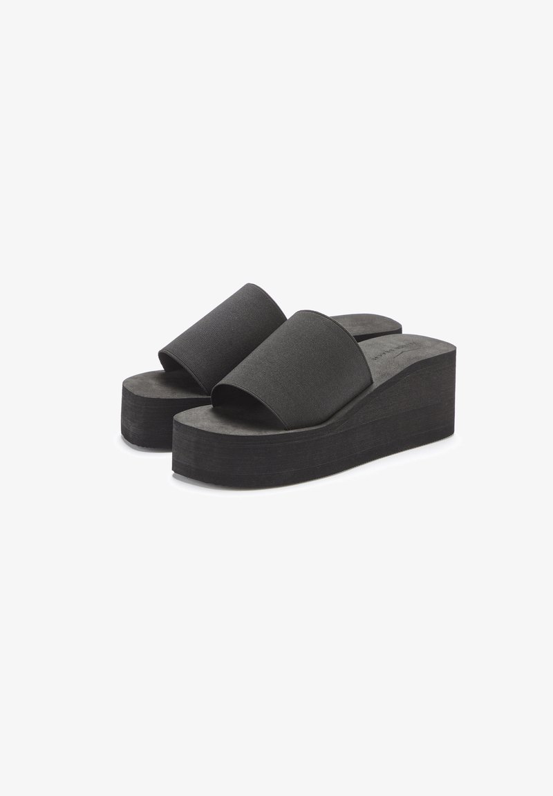 Black platform sandals with double fabric straps and a textured footbed. The sole is thick and ridged for stability and comfort.