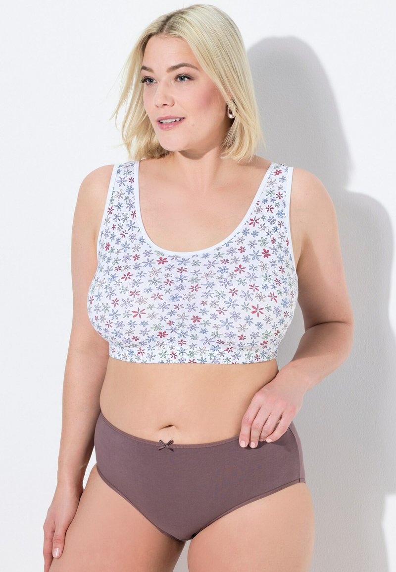 Vit kort topp med färggårdigt blommönster, parat med bruna högmidjade underkläder med en liten rosett som detalj. Slät textur.