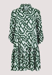 Grün-weiß gemustertes Hemdkleid mit Kragen, Knopfleiste und geschichtetem Rüschensaum. Aus weichem Stoff mit geometrischem Design.