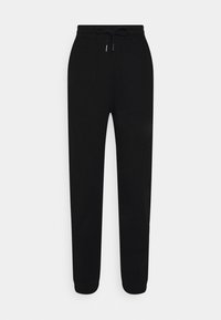 Svarta träningsbyxor i mjukt tyg, med resårmidja och dragsko, taperade ben och ribbade muddar vid anklarna.