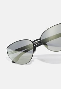 Black cat-eye sunglasses with gradient green lenses, metal frame, and prominent nose bridge. Features minimal branding on the temple.
