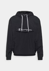 Schwarze Champion-Pulloverjacke mit Kapuze, weißen Kordelzügen, einer aufgesetzten Fronttasche und elastischen Bündchen.