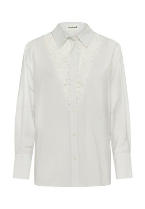 Valge triibuline pluus pitsilise sissekandega disainiga, terava kraega ja nööpidega ees. Pikad varrukad mansettidega. Pehme tekstuur.