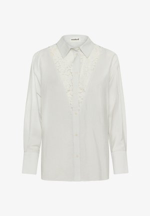 Valge triibuline pluus pitsilise sissekandega disainiga, terava kraega ja nööpidega ees. Pikad varrukad mansettidega. Pehme tekstuur.