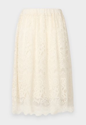 Lace skirt in cream color featuring a textured floral pattern, elastic waist, and a scalloped hem for added detail.