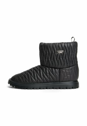 Schwarzer gesteppter Knöchelstiefel mit dicker Gummisohle und "Tommy Jeans" Logo auf der Seite, mit gepolstertem Zickzack-Nähdesign.