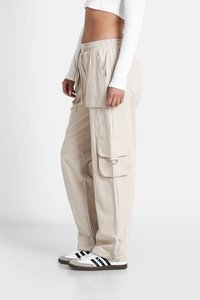 Beige cargobroek met een elastische tailleband, zijzakken en trekkoorden. Gemaakt van een lichtgewicht stof, met een ontspannen pasvorm en verstelbare manchetten.