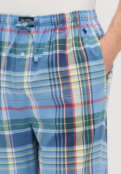 Svītrainas šortas gaiši zilā krāsā, ar dažādiem svītrām zaļā, dzeltenā un sarkanā krāsā. Elastīga jostasvieta ar aukliņu un sānu kabatām.