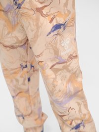 Beige pants with orange, purple, and brown abstract pattern, featuring a white hummel logo on the upper thigh.