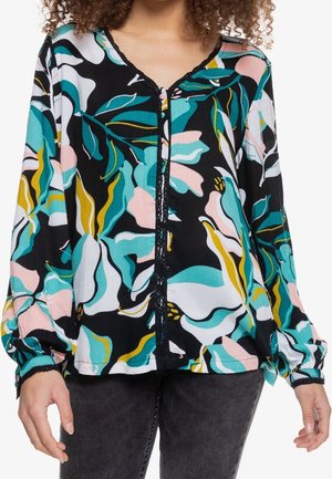 Blomstret bluse i sort med store turkise, pink og gule kronblade, rund halsudskæring og lange puffede ærmer med elastiske manchetter.