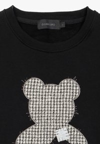 Zwarte sweatshirts met een geweven beige en grijze teddybeer graphic, gedetailleerd met stiksels en een textuurpatroon. Merkenlabel zichtbaar.
