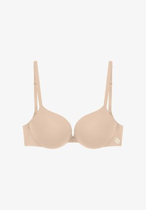 Soutien-gorge beige rembourré avec armatures, bretelles réglables et petit logo blanc sur le côté gauche de la bande.