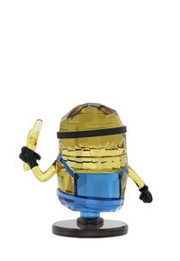 A crystal figurine of a yellow, round character wearing gloves and blue overalls, striking a playful pose with a banana in one hand.