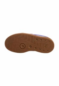 Suola in gomma con un motivo ondulato, nodi circolari e sporgenti, e un logo. Il colore è marrone chiaro con una texture liscia.