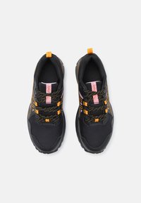 Black athletic shoes featuring a mesh upper with orange and yellow accents, textured laces, and a sturdy rubber sole.