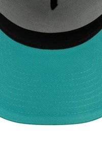 Turquoise cap with a black brim, featuring a structured design and textured fabric. Interior is grey with visible stitching details.
