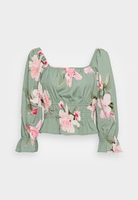 Blusa verde corta con stampa floreale rosa, maniche lunghe a sbuffo, scollatura quadrata, vita arricciata e polsini con volant.