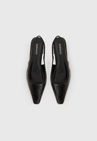 Black slingback high heels featuring a pointed toe, textured finish, and a smooth interior with branding, positioned on a neutral background.
