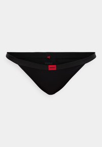 Μαύρο μπικίνι στρινγκ από λείο υλικό, με φαρδιά ζώνη μέσης που φέρει κόκκινη ετικέτα με το λογότυπο και λεπτές λεπτομέρειες.